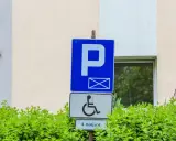 Znak parkingowy dla osób z niepełnosprawnościami, wskazujący 4 miejsca. Informuje o udogodnieniach dla osób z różnymi stopniami niepełnosprawności.