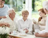 Uśmiechnięci seniorzy cieszą się wspólnym popołudniem, pokazując, że starzenie się organizmu nie musi oznaczać samotności.