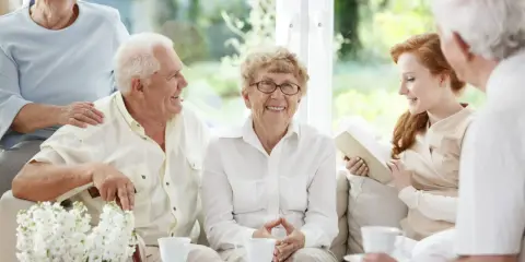 Uśmiechnięci seniorzy cieszą się wspólnym popołudniem, pokazując, że starzenie się organizmu nie musi oznaczać samotności.